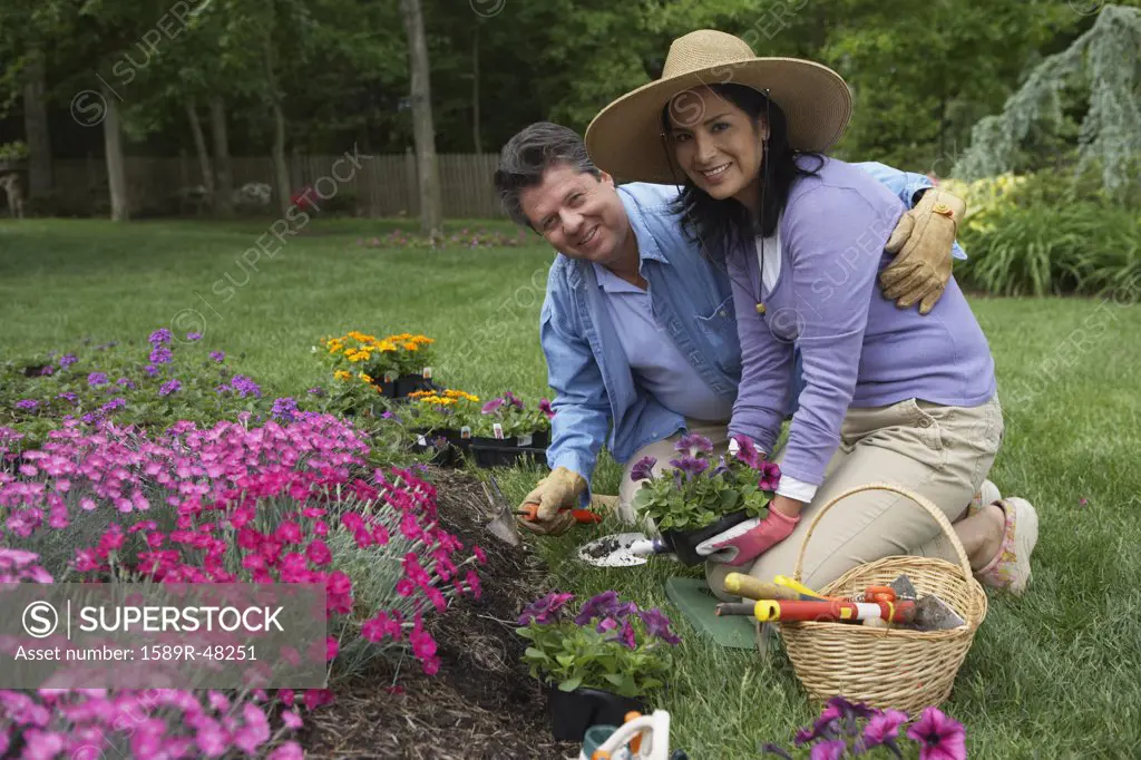 Hispanic couple gardening