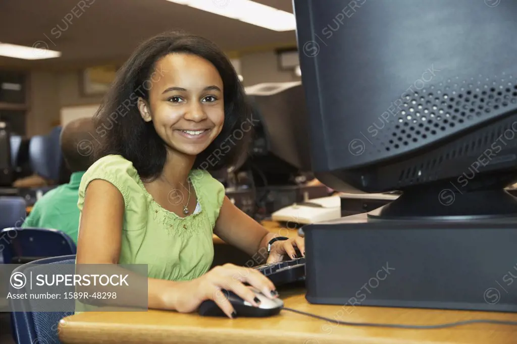 African American girl using school computer