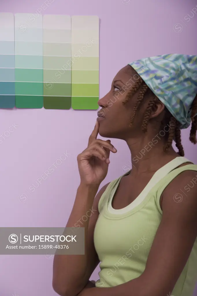African American woman looking at paint swatches