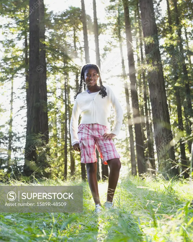 African girl standing in woods
