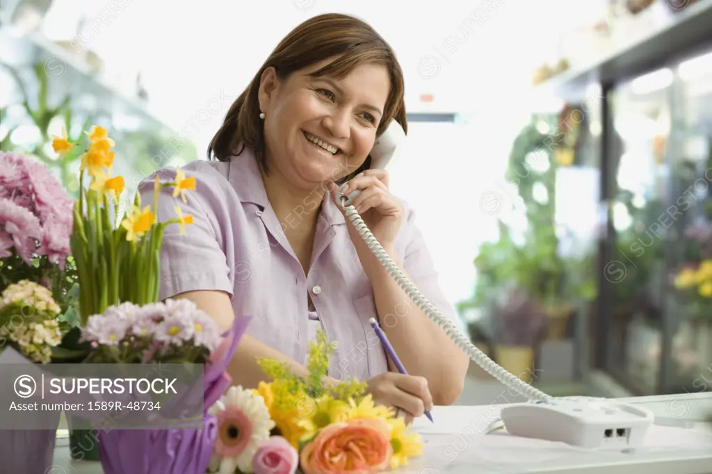 Hispanic woman working in florist shop