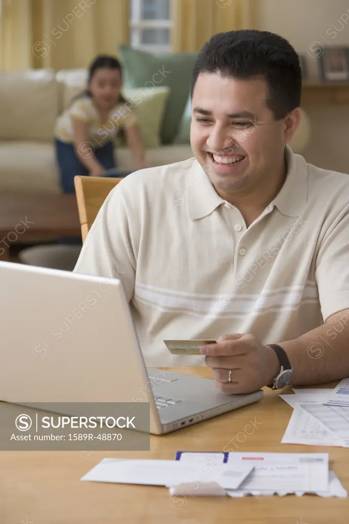 Hispanic man shopping online