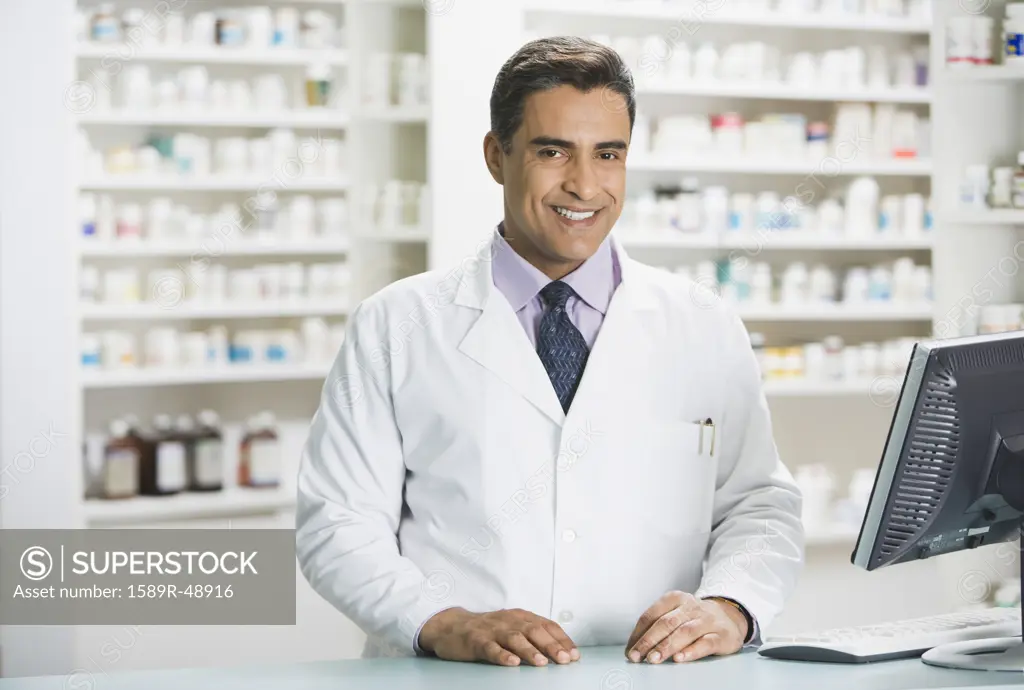 Hispanic male pharmacist behind counter