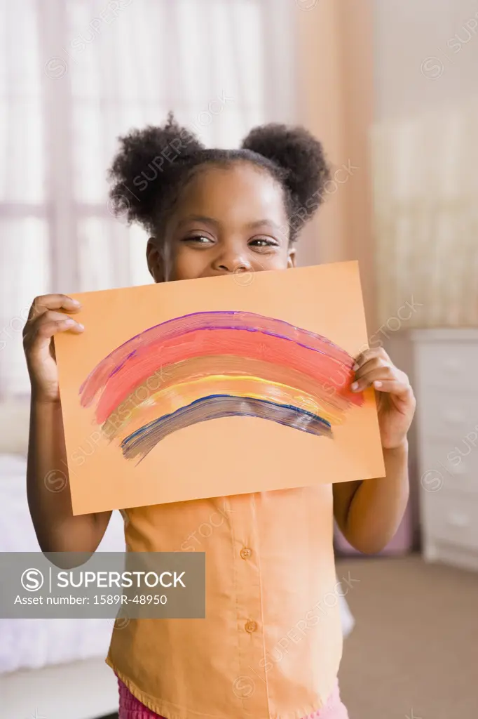 African American girl holding up painting