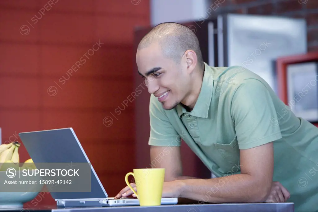 African American man looking at laptop