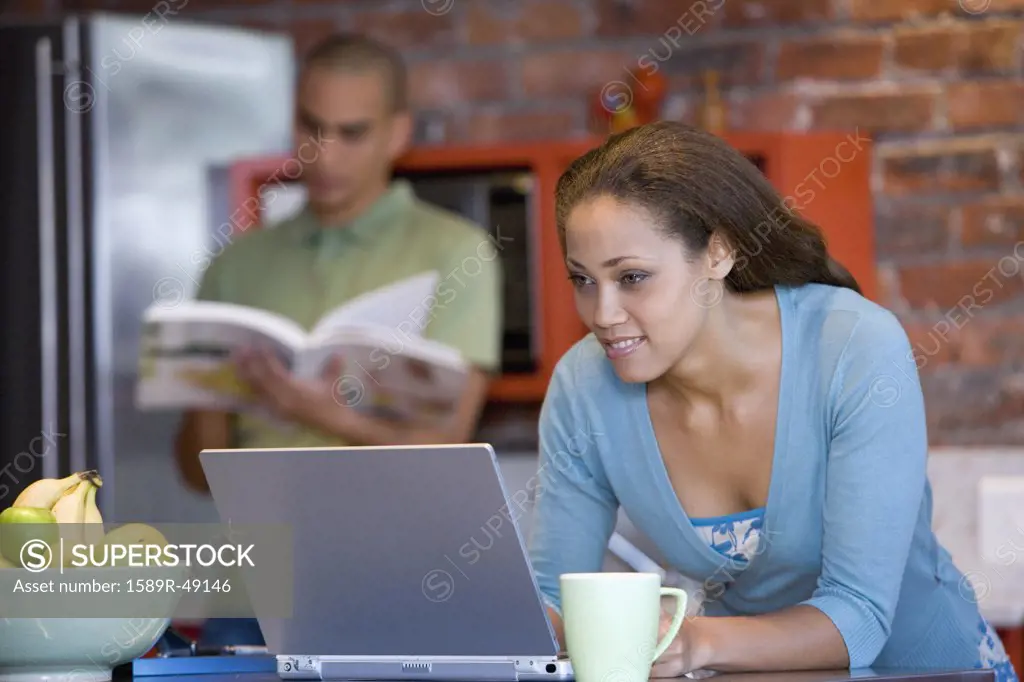 African American woman looking at laptop