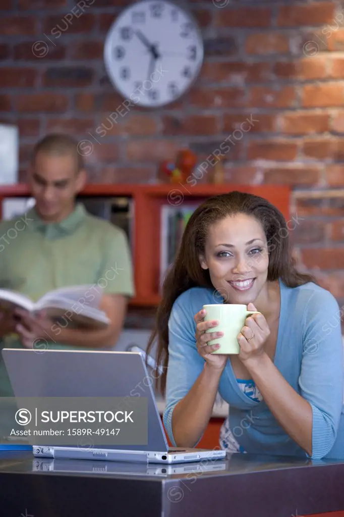 African American woman holding coffee mug