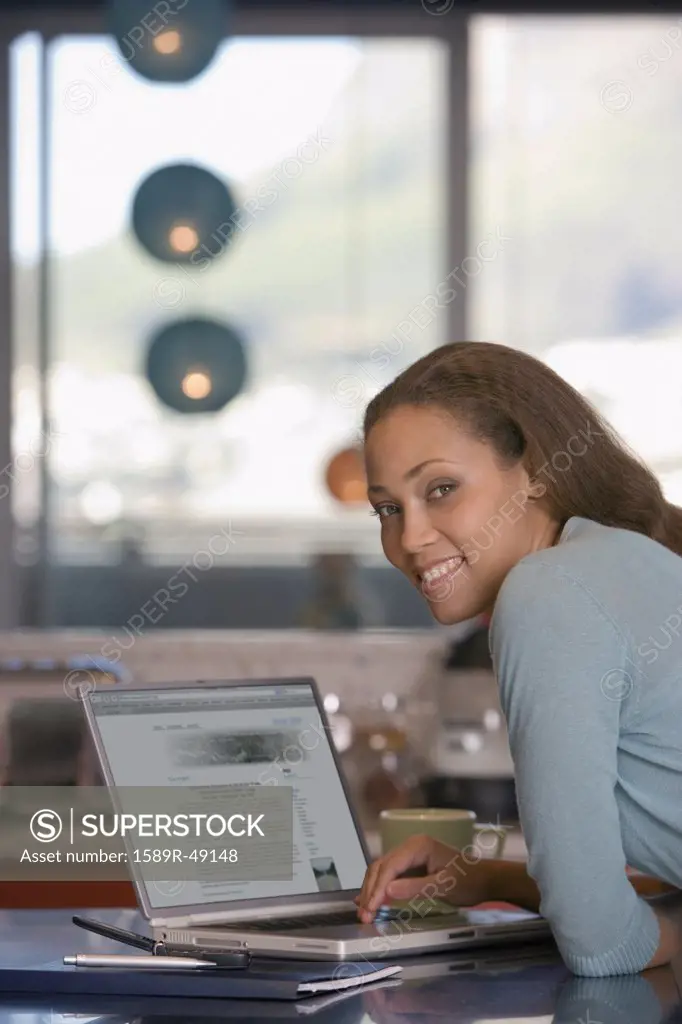 African American woman next to laptop