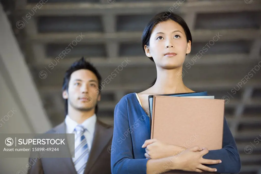 Asian businesswoman holding folders