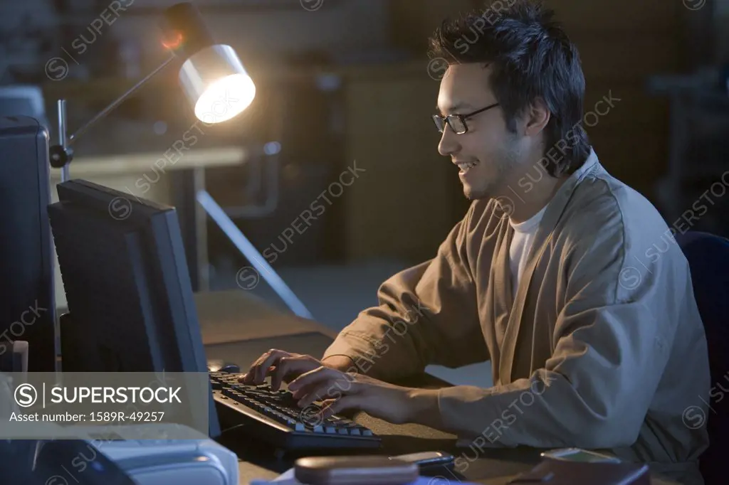 Asian businessman typing on computer