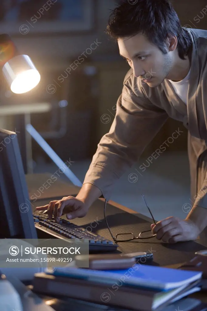 Asian businessman typing on computer