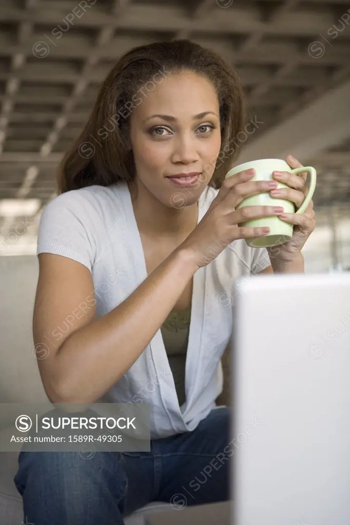 African American woman holding coffee mug