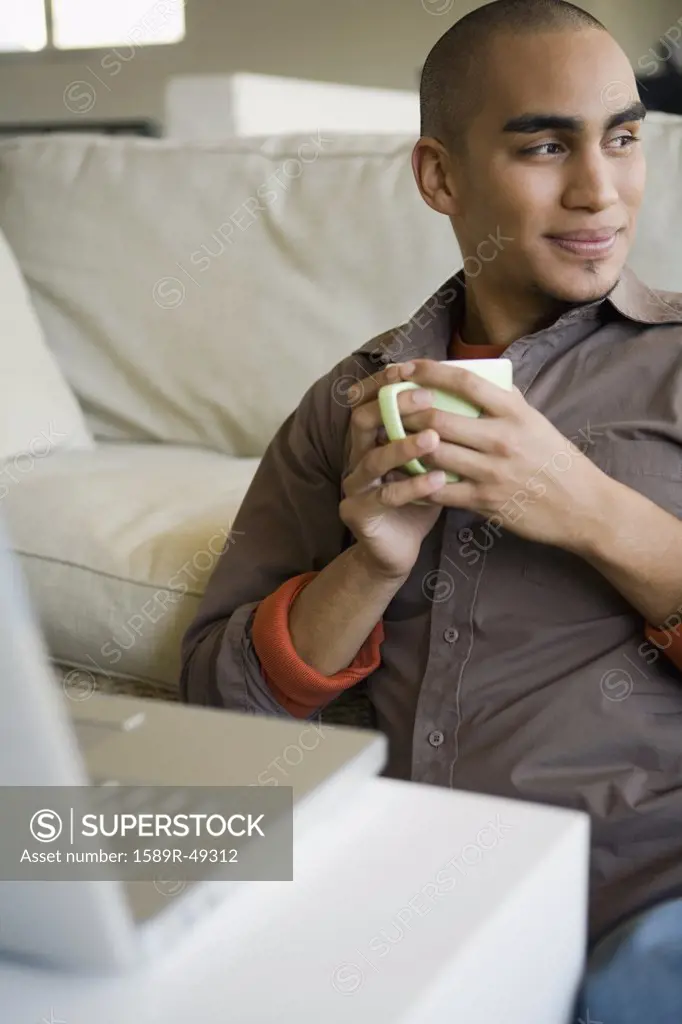 African American man holding coffee mug