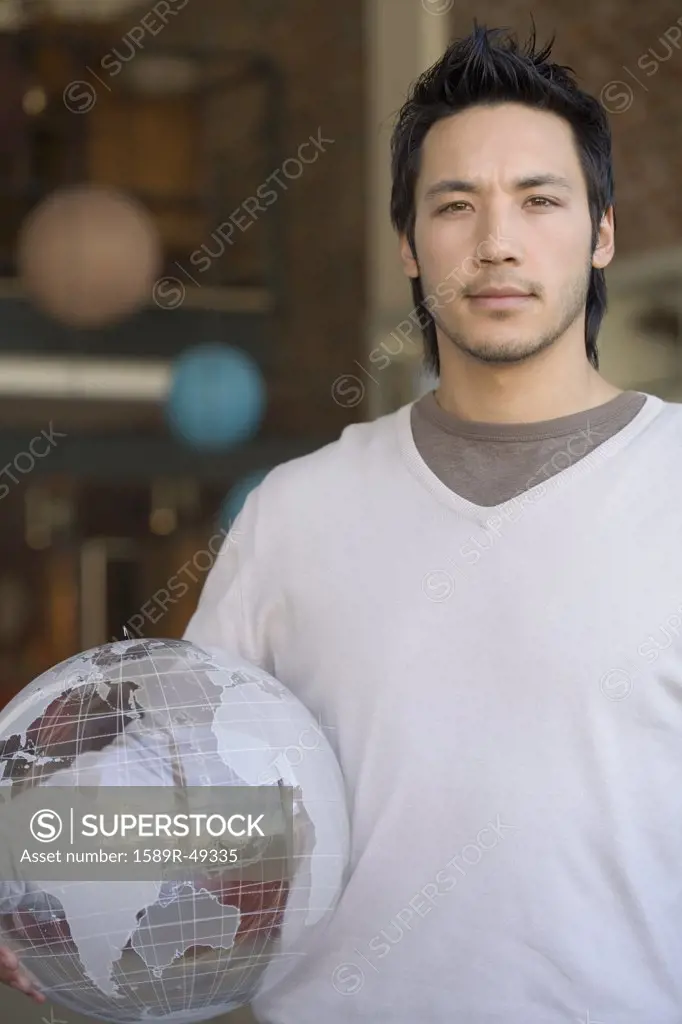Asian man holding globe
