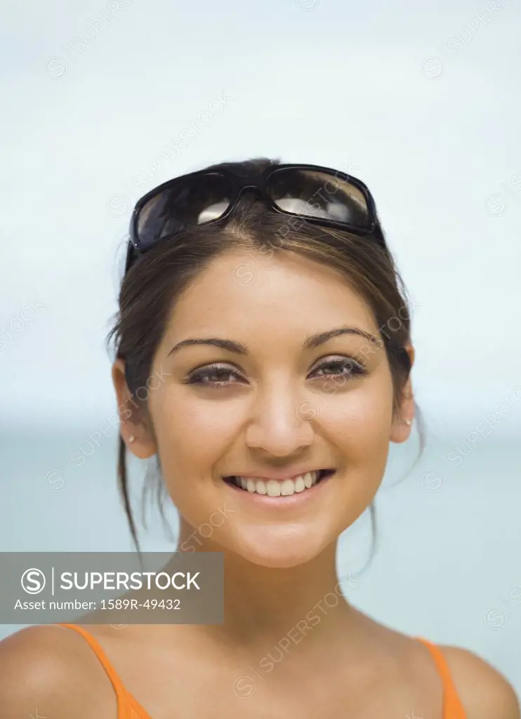 Asian woman with sunglasses on head