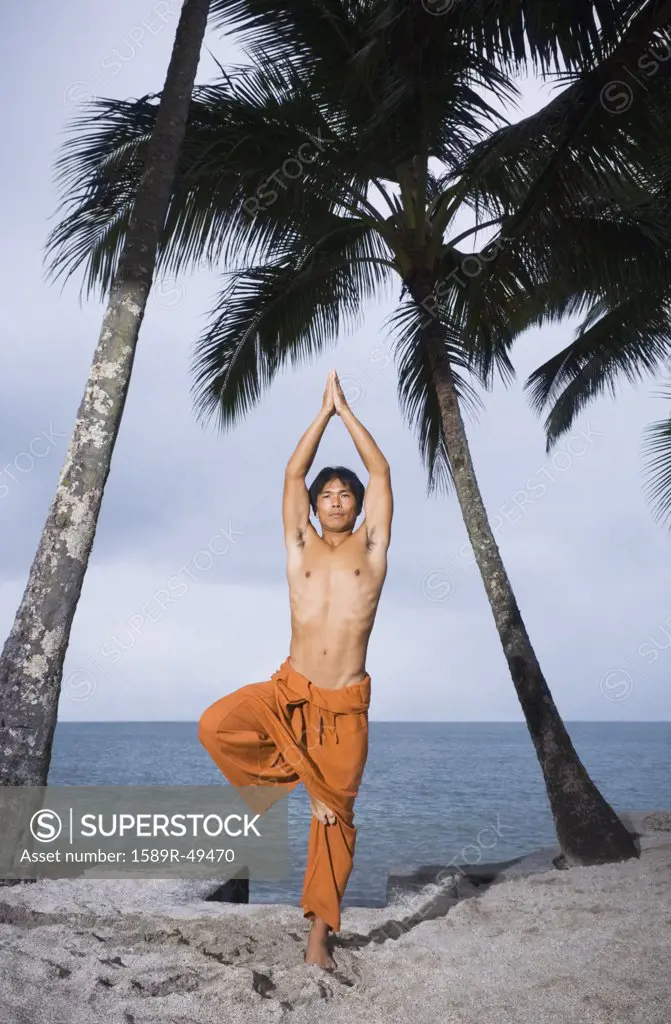 Asian man practicing yoga