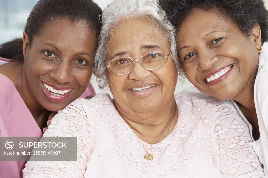 Senior African American woman with nurse and daughter