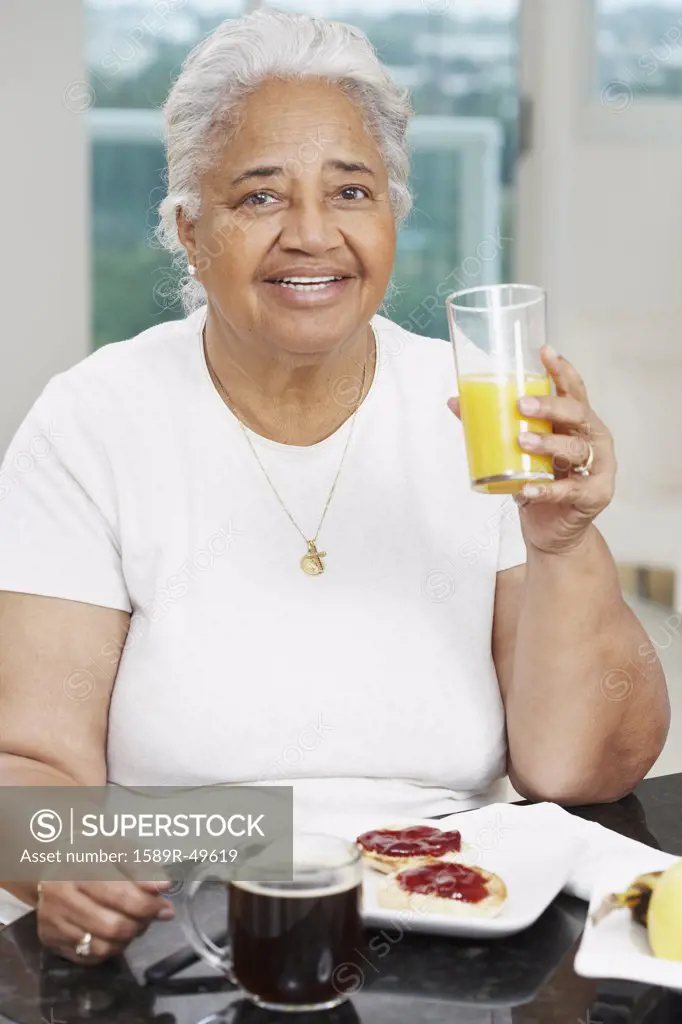 Senior African American woman eating breakfast