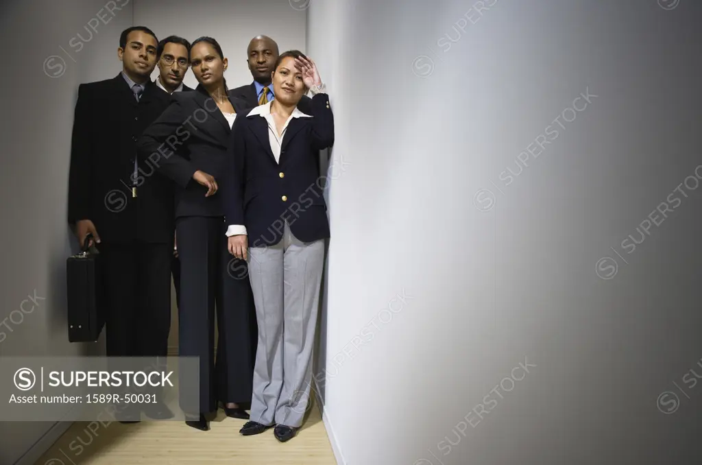 Multi-ethnic businesspeople in hallway