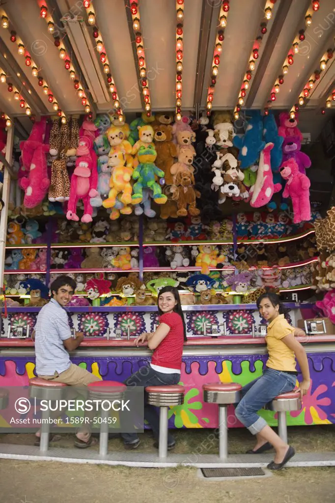 Multi-ethnic teenaged friends at carnival booth