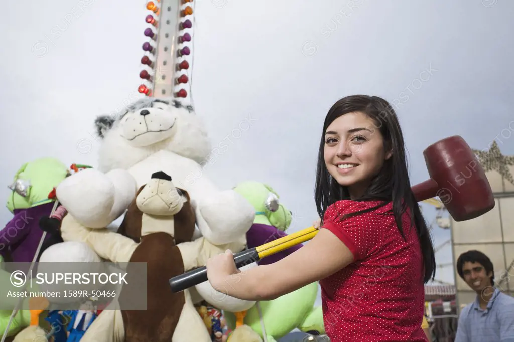 Mixed Race teenaged girl playing carnival game 