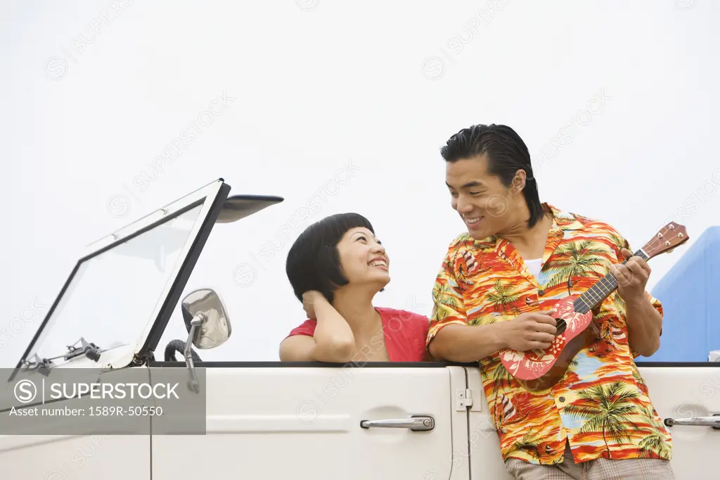 Asian couple smiling at each other