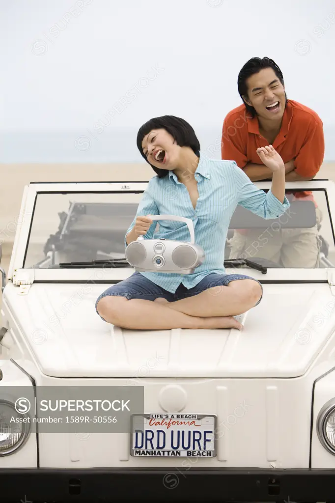 Asian couple listening to portable radio