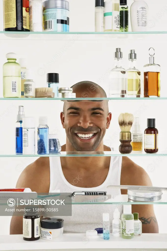 African American man looking in medicine cabinet
