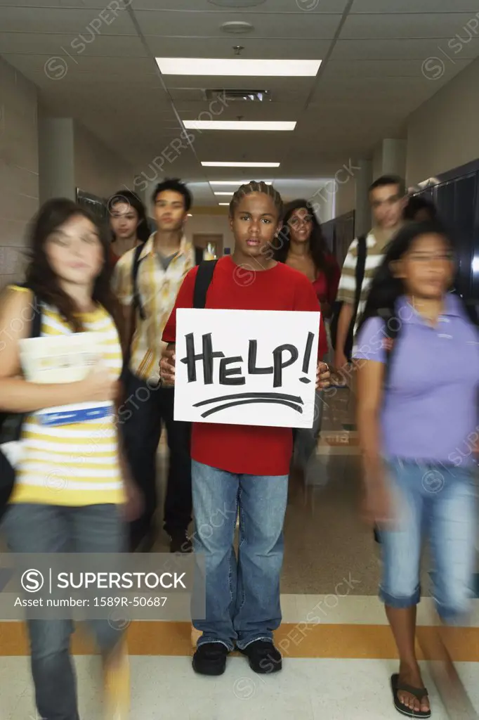 African American teenaged student holding Help sign