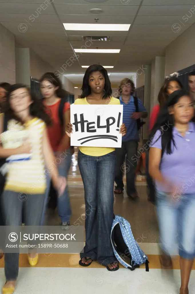 African American teenaged student holding Help sign