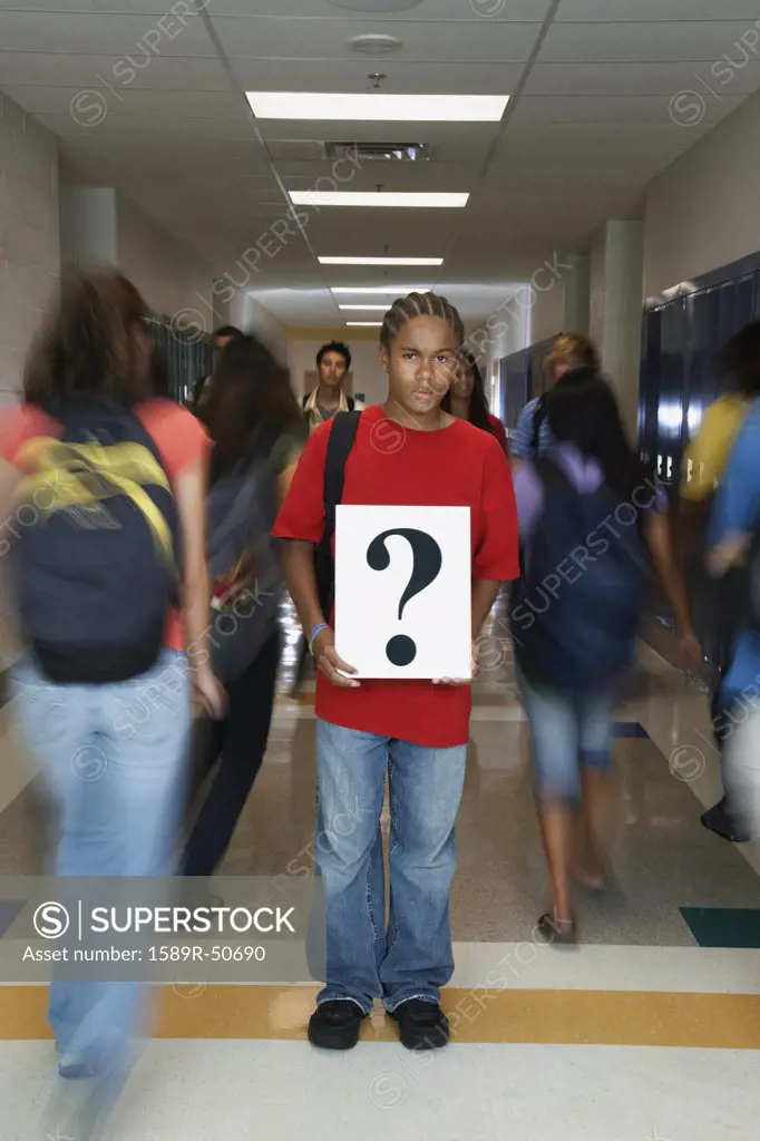 African American teenaged student holding question mark sign