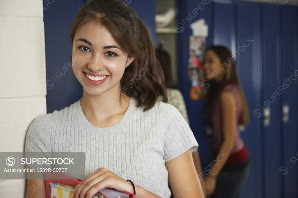 Teenaged girl in front of school lockers