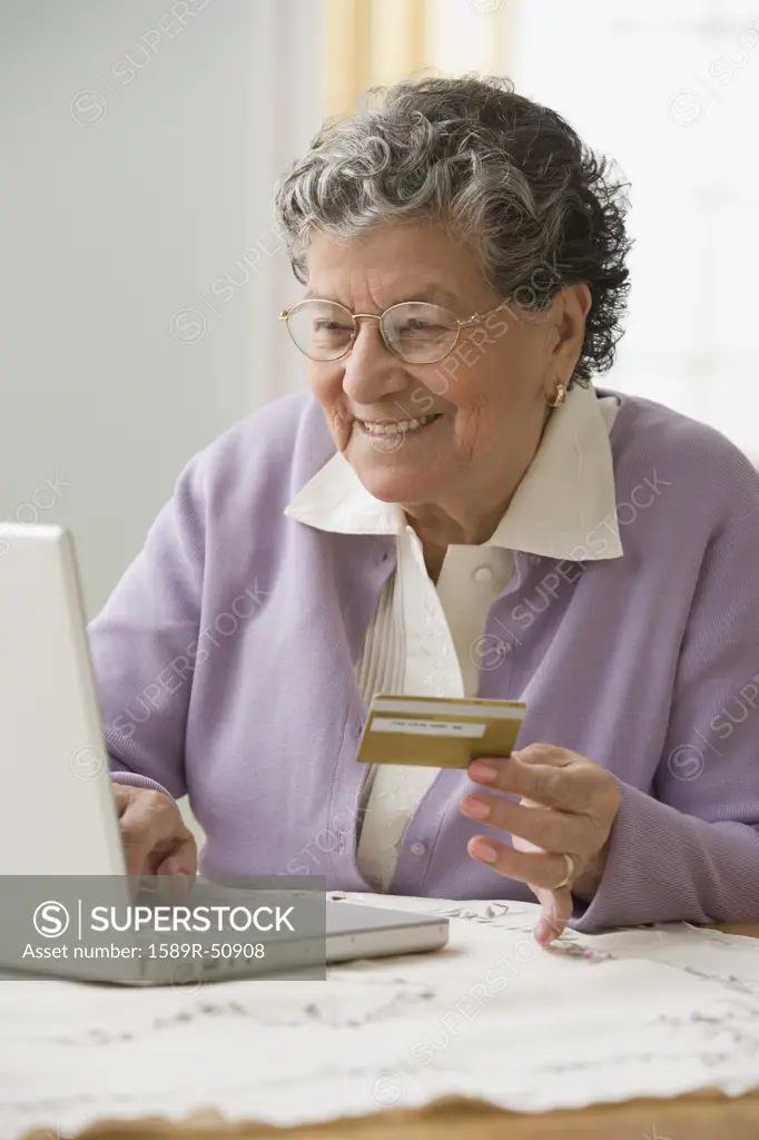 Senior Hispanic woman shopping online