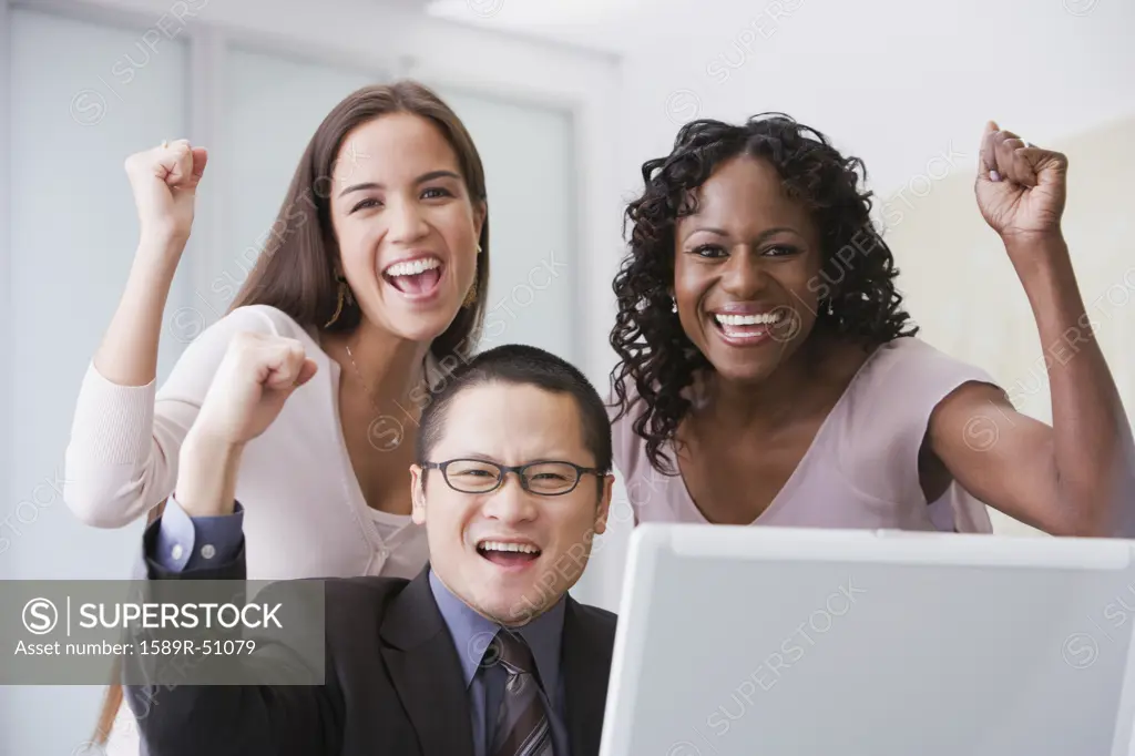 Multi-ethnic businesspeople cheering