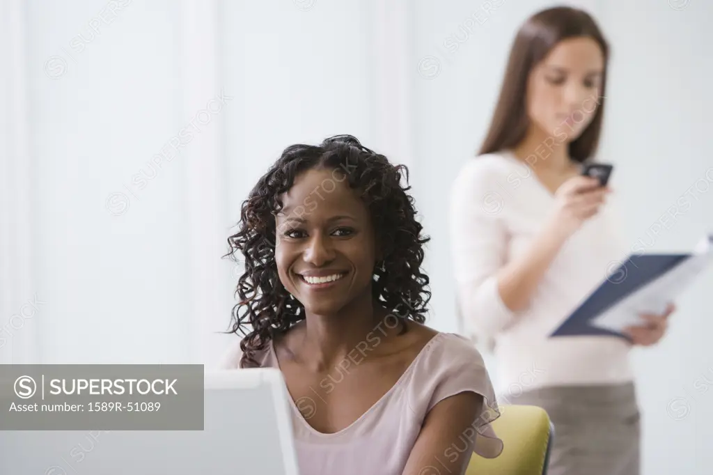 African American businesswoman sitting at laptop