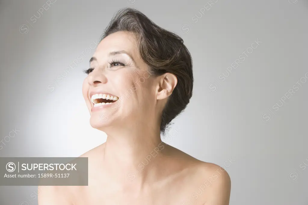 Hispanic woman with bare shoulders laughing