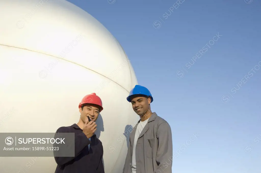 Multi-ethnic male construction workers with walkie talkie