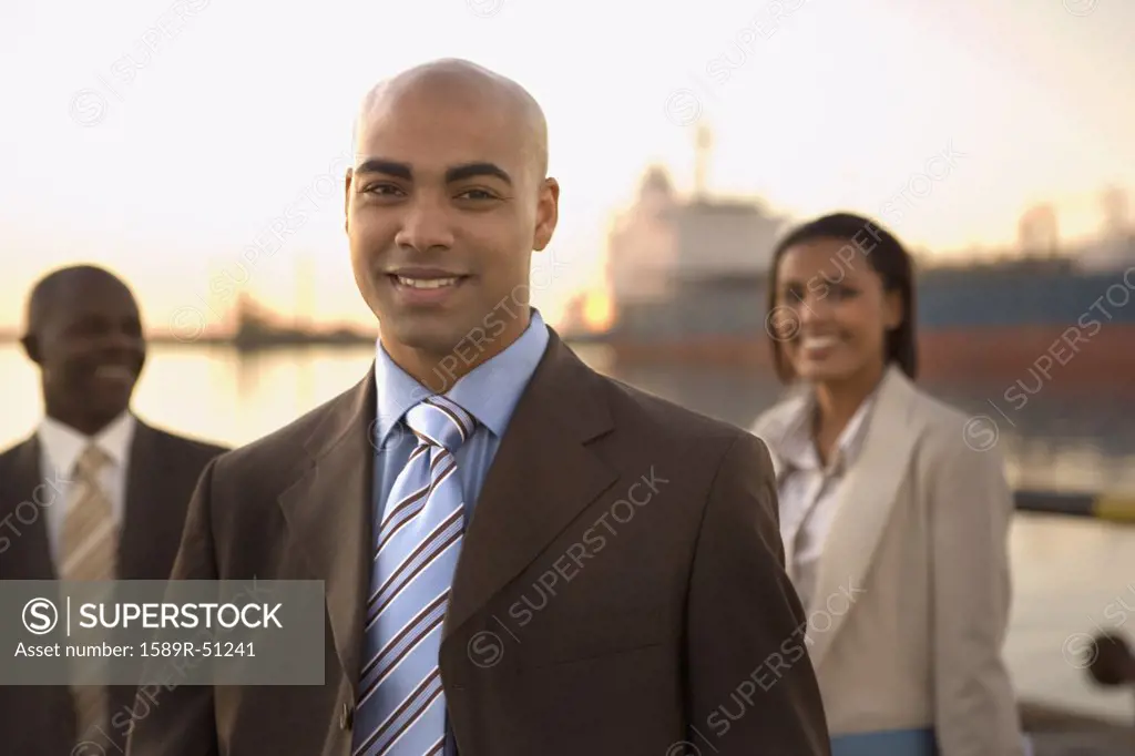 African American businesspeople in front of freighter