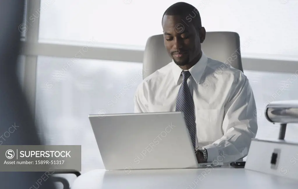 African American businessman typing on laptop