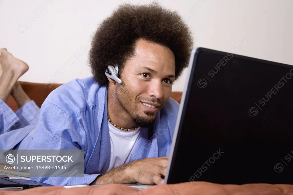 African man typing on laptop