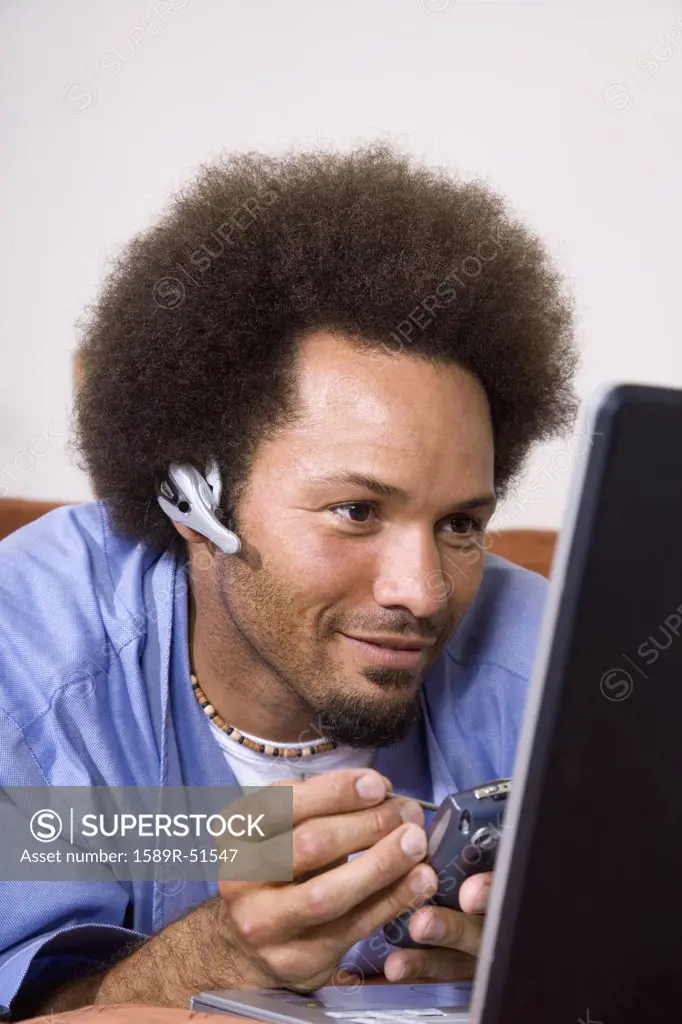 African man using electronic organizer