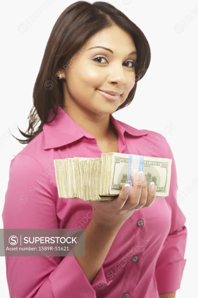 Asian woman holding stack of money