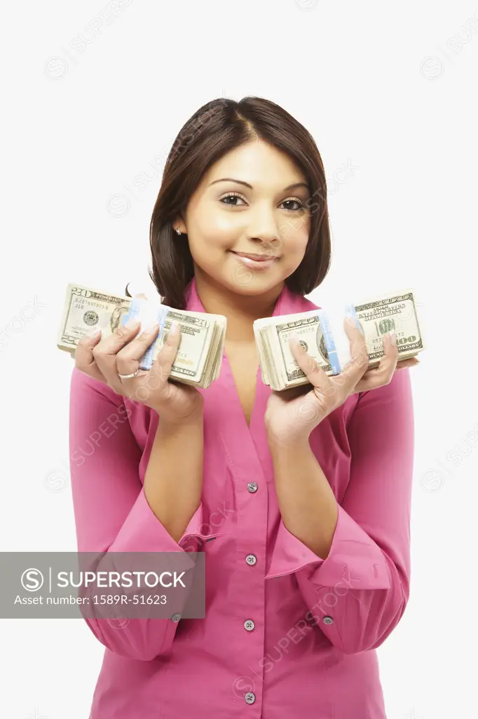 Asian woman holding stacks of money
