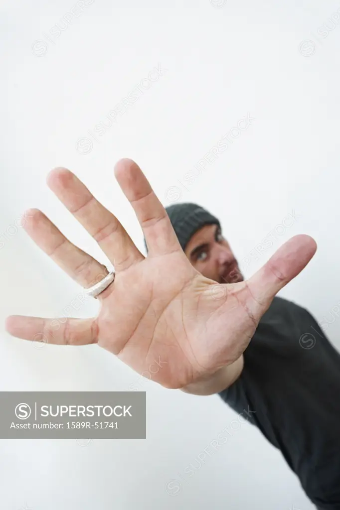 Hispanic man making stop gesture