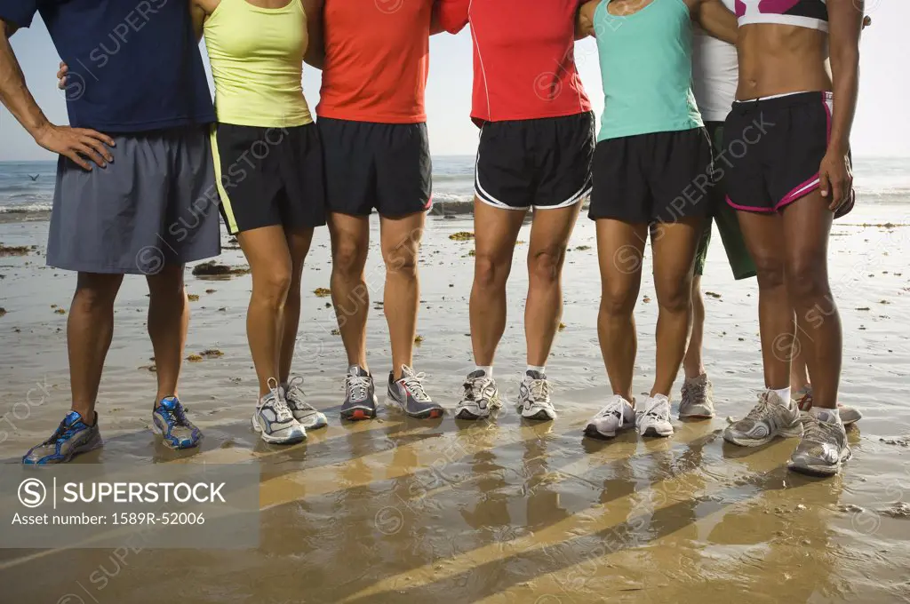 Multi-ethnic runners at beach