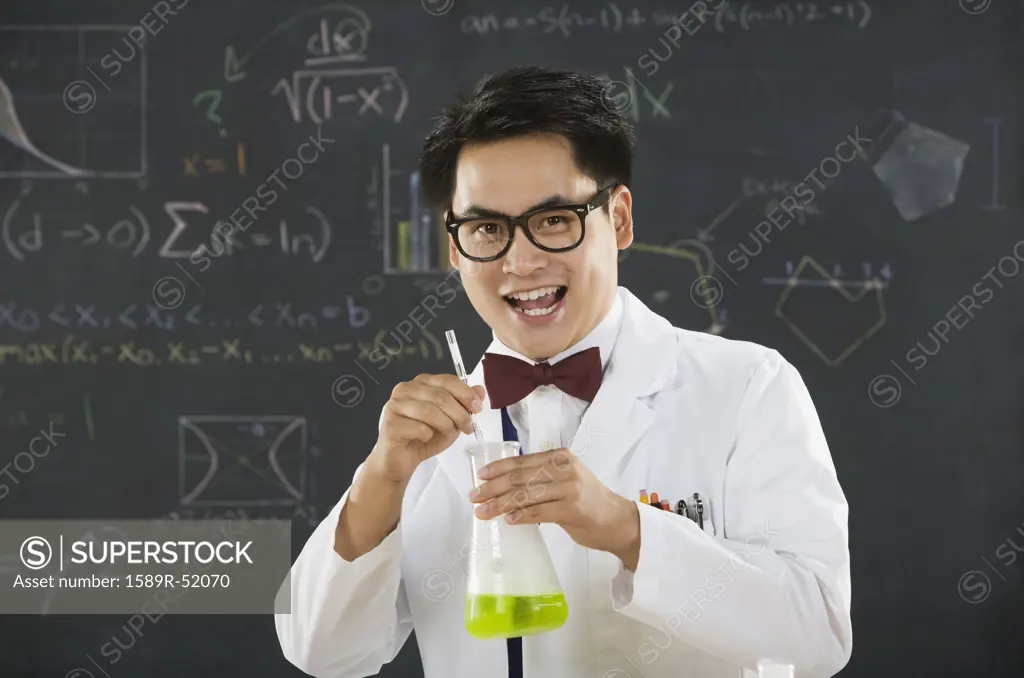 Nerdy Asian male student in science class