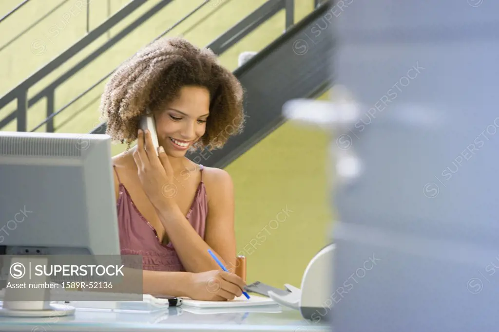 African businesswoman talking on telephone