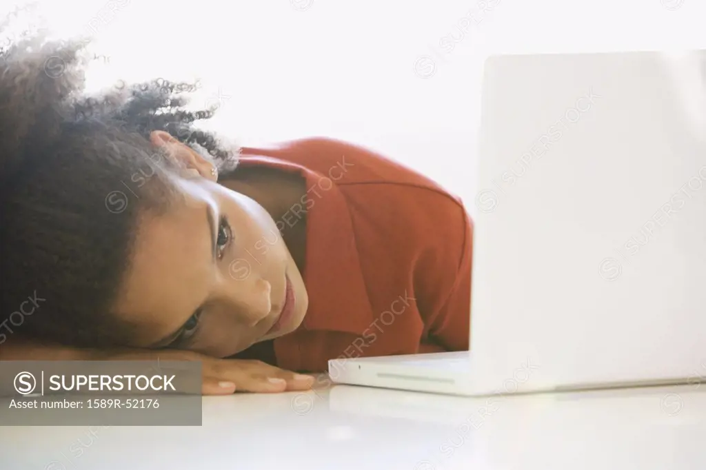 African woman looking at laptop
