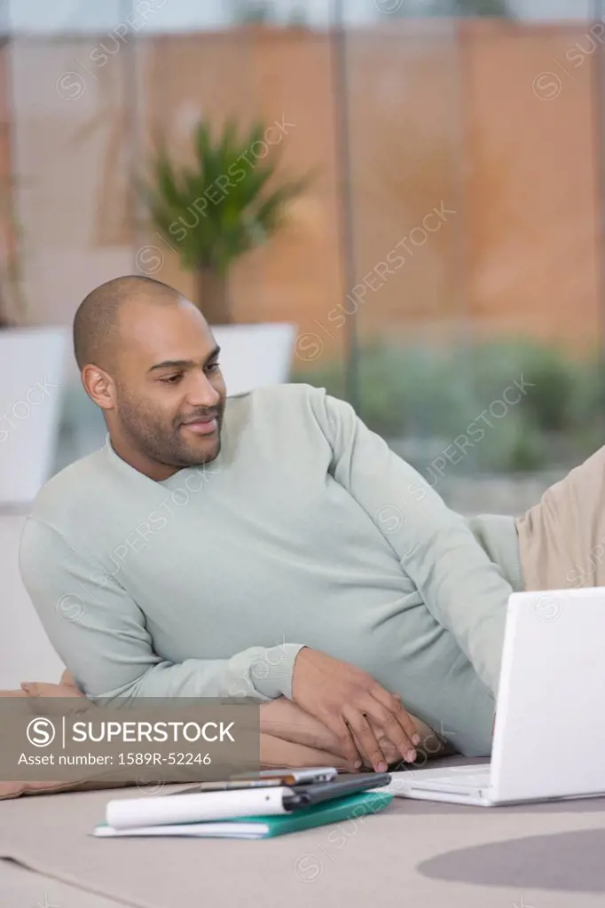 African businessman looking at laptop