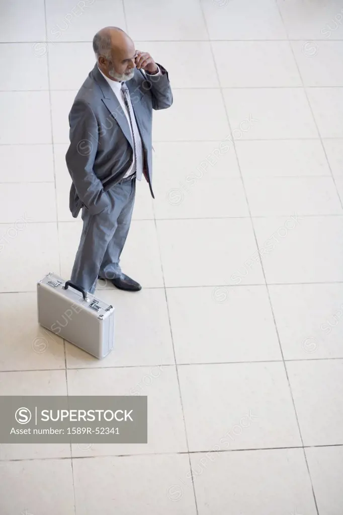 Senior African businessman talking on cell phone